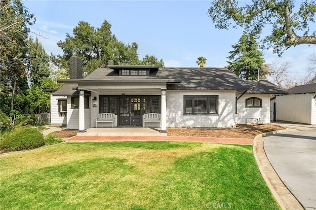 exterior space featuring a front yard and covered porch