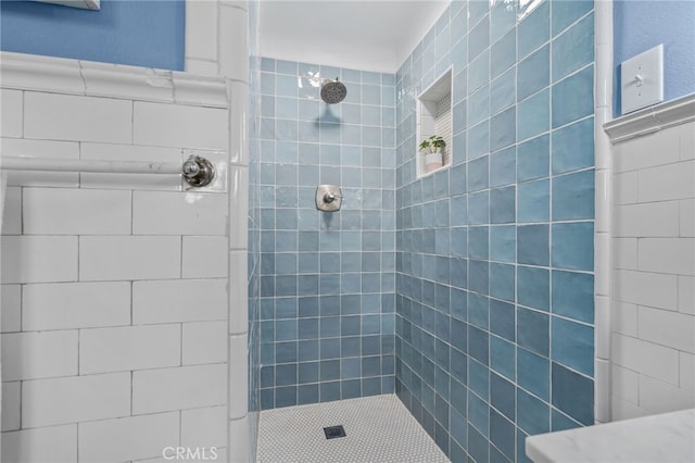 bathroom with a tile shower