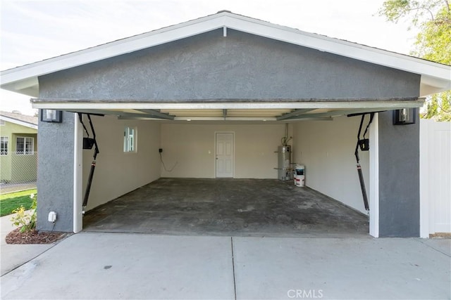 garage with strapped water heater and a carport