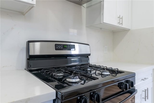 kitchen with white cabinets and black gas range