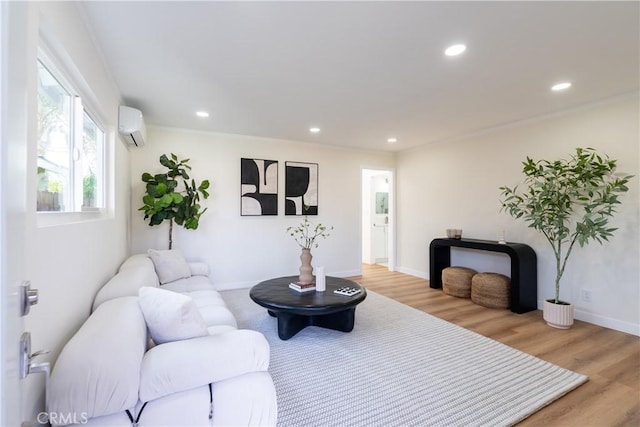 living room featuring a wall mounted air conditioner and light hardwood / wood-style floors