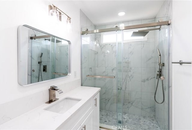 bathroom with walk in shower and vanity