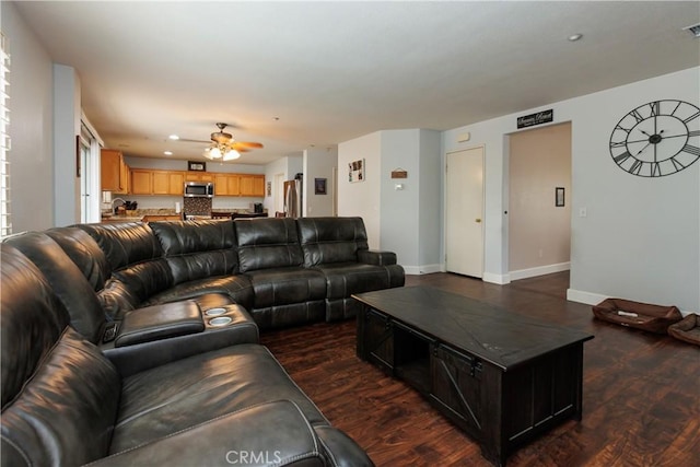 living room with dark hardwood / wood-style floors and ceiling fan