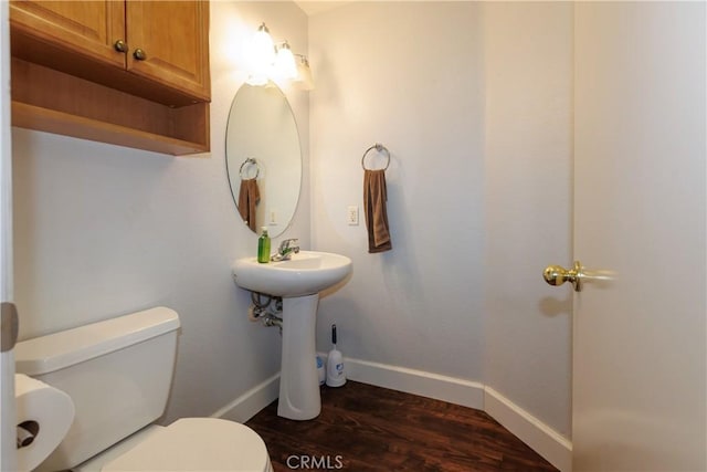 bathroom with hardwood / wood-style floors and toilet