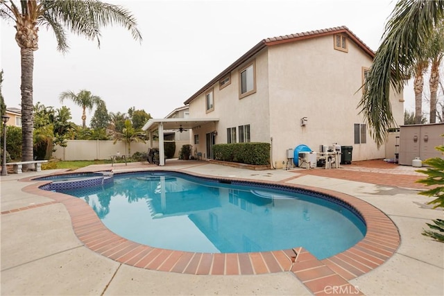 view of pool featuring an in ground hot tub and a patio area