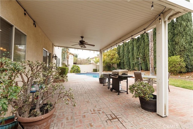 view of patio with a fenced in pool, a grill, and ceiling fan