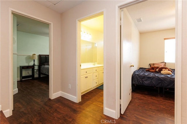 hallway featuring sink and dark hardwood / wood-style flooring