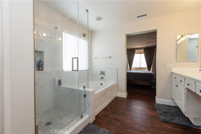 bathroom featuring vanity, separate shower and tub, and hardwood / wood-style floors