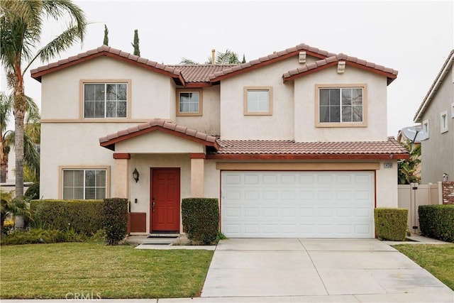 mediterranean / spanish-style house featuring a garage and a front lawn