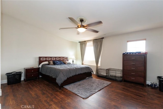 bedroom with multiple windows, vaulted ceiling, and dark wood-type flooring