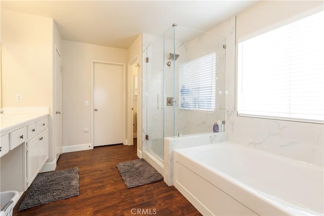 bathroom with vanity, hardwood / wood-style floors, and separate shower and tub