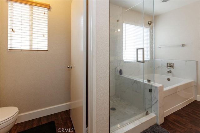 bathroom with wood-type flooring, separate shower and tub, and toilet