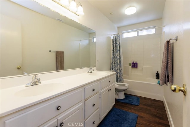 full bathroom featuring vanity, wood-type flooring, shower / bath combination with curtain, and toilet