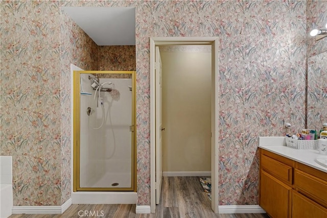 bathroom featuring vanity, hardwood / wood-style floors, and a shower with shower door