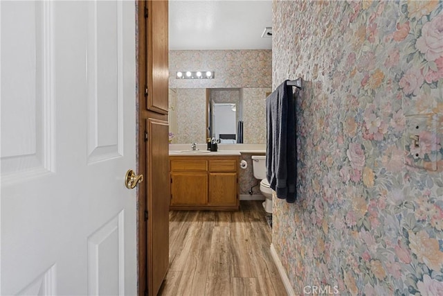 bathroom with vanity, hardwood / wood-style floors, and toilet