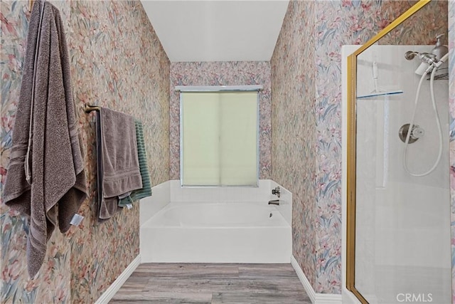 bathroom featuring shower with separate bathtub and hardwood / wood-style floors