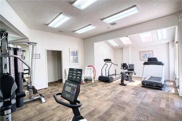 gym with carpet and a textured ceiling