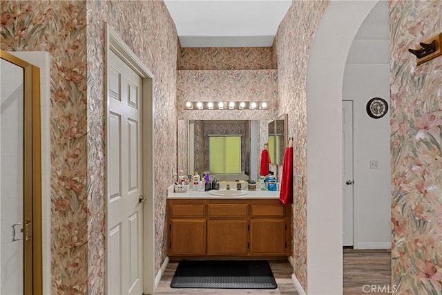 bathroom with vanity, hardwood / wood-style floors, and walk in shower