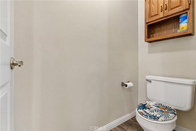 bathroom featuring hardwood / wood-style flooring and toilet