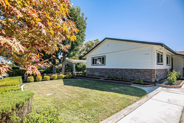 view of side of home featuring a lawn