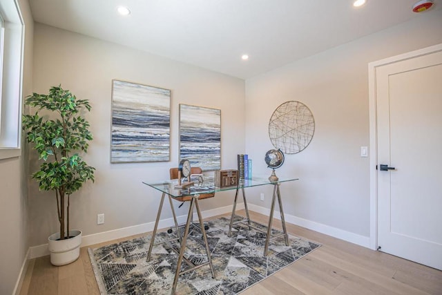 office area with light hardwood / wood-style floors