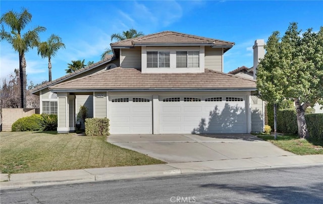 view of front property with a garage and a front yard