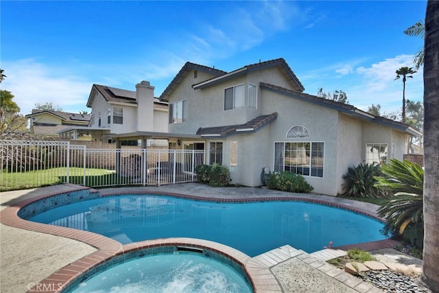 view of swimming pool featuring an in ground hot tub