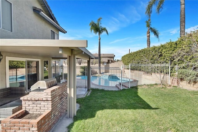 exterior space featuring a fenced in pool, an outdoor kitchen, and a patio area