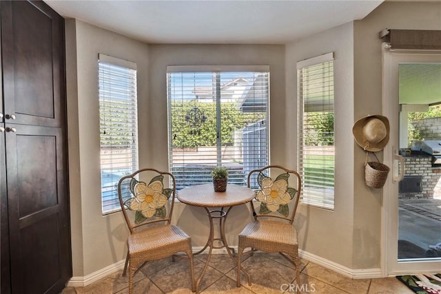 living area with light tile patterned flooring and a healthy amount of sunlight