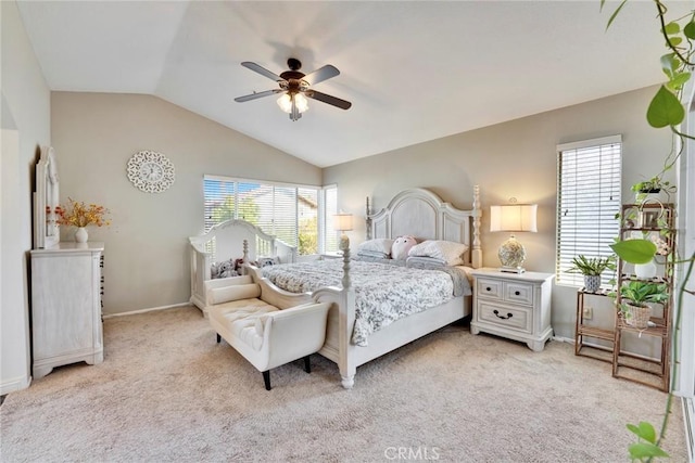 carpeted bedroom featuring ceiling fan and vaulted ceiling