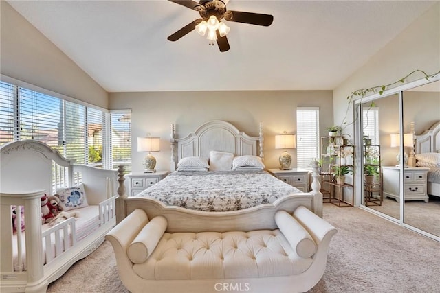 bedroom featuring lofted ceiling, light colored carpet, and ceiling fan