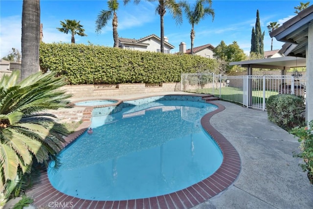 view of swimming pool featuring an in ground hot tub