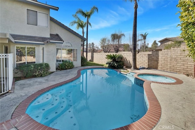 view of swimming pool with an in ground hot tub and a patio