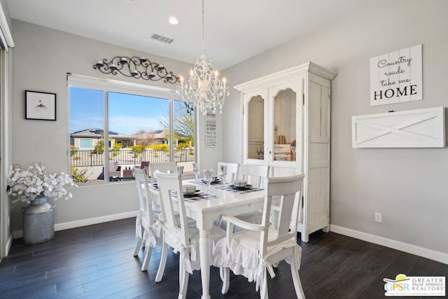 dining room with an inviting chandelier and dark hardwood / wood-style floors