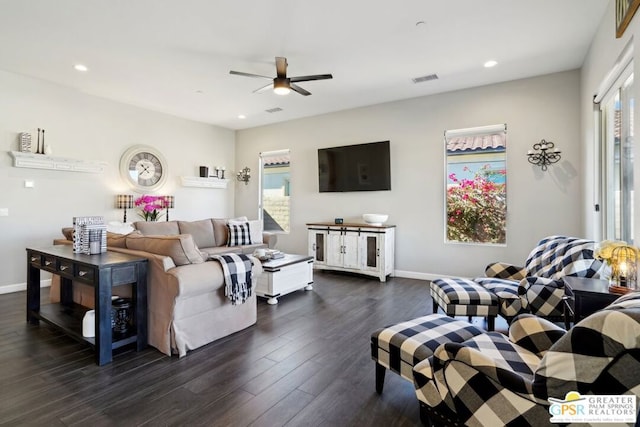 living room with dark wood-type flooring and ceiling fan