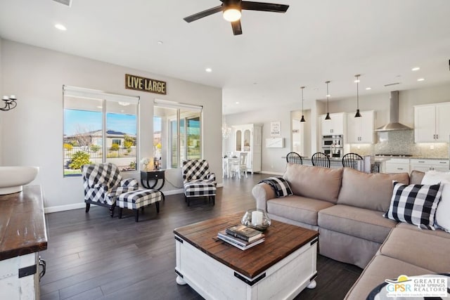 living room with ceiling fan and dark hardwood / wood-style flooring