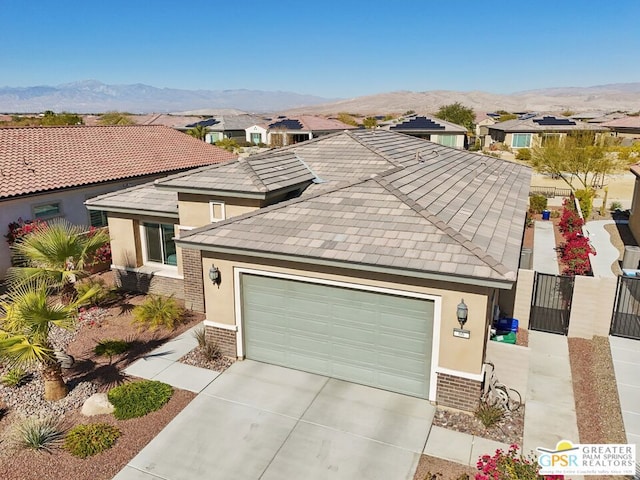 view of front of property with a mountain view and a garage