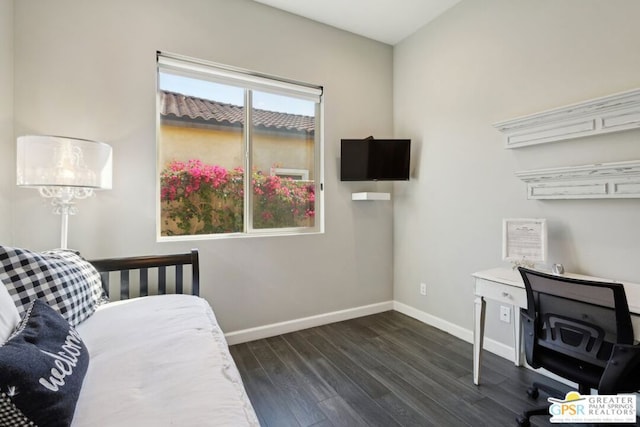 bedroom with dark hardwood / wood-style flooring