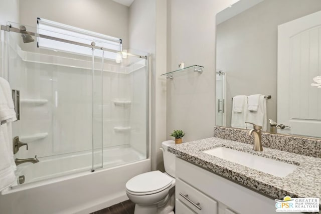 full bathroom with vanity, shower / bath combination with glass door, and toilet