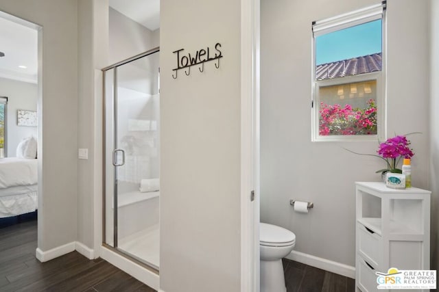 bathroom with vanity, hardwood / wood-style floors, a shower with shower door, and toilet