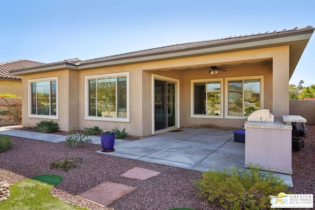 back of house featuring ceiling fan, exterior kitchen, and a patio area