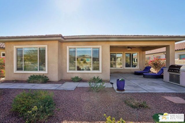 back of property with ceiling fan and a patio