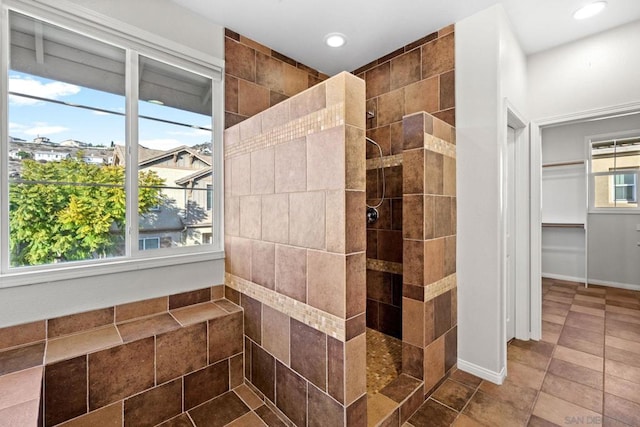 bathroom featuring a tile shower and tile patterned floors