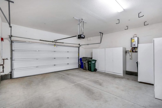 garage with a garage door opener and water heater