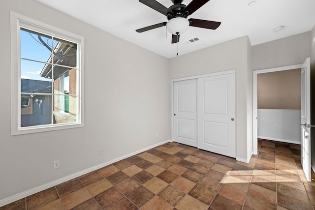 unfurnished bedroom with a closet and ceiling fan