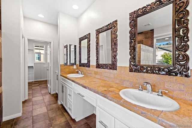 bathroom with vanity and decorative backsplash