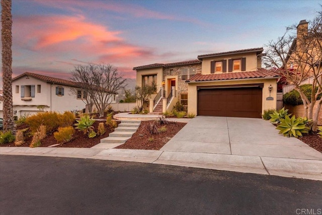 mediterranean / spanish-style home with a garage