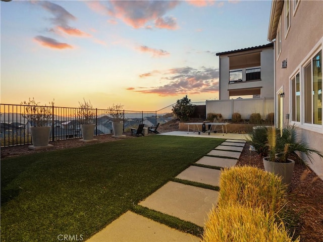 yard at dusk with a patio area