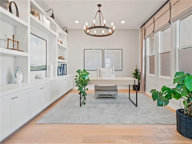 sitting room featuring a notable chandelier and light hardwood / wood-style floors