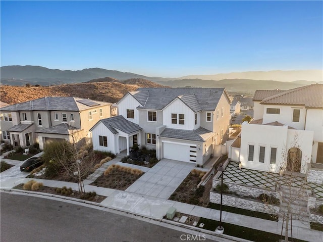 view of front of house featuring a garage and a mountain view